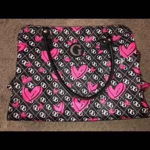 Big black purse by Guess with pink hearts